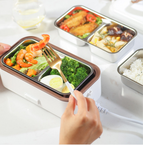 The electric lunch box  plugged into the electric heating, heat preservation, cooking and hot rice artifact