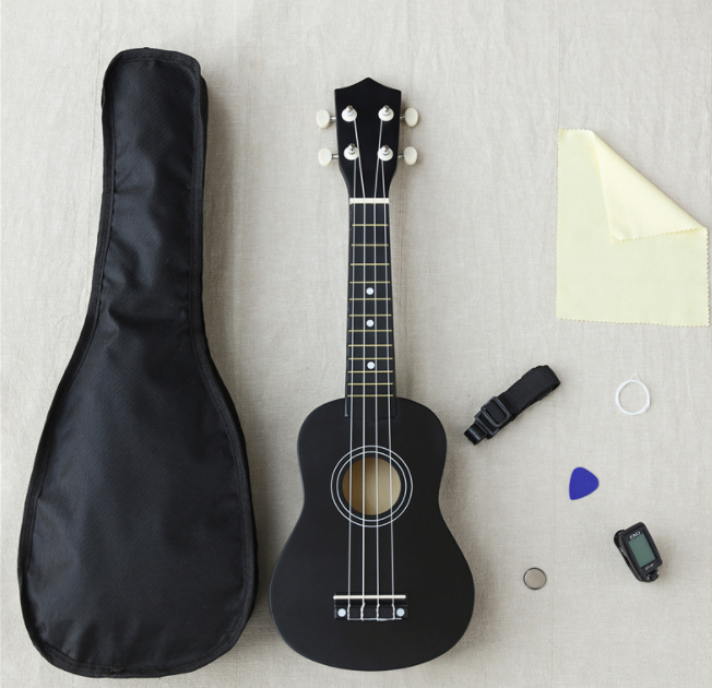 21 inch wooden ukulele with: English book, piano bag, tuner, etc.